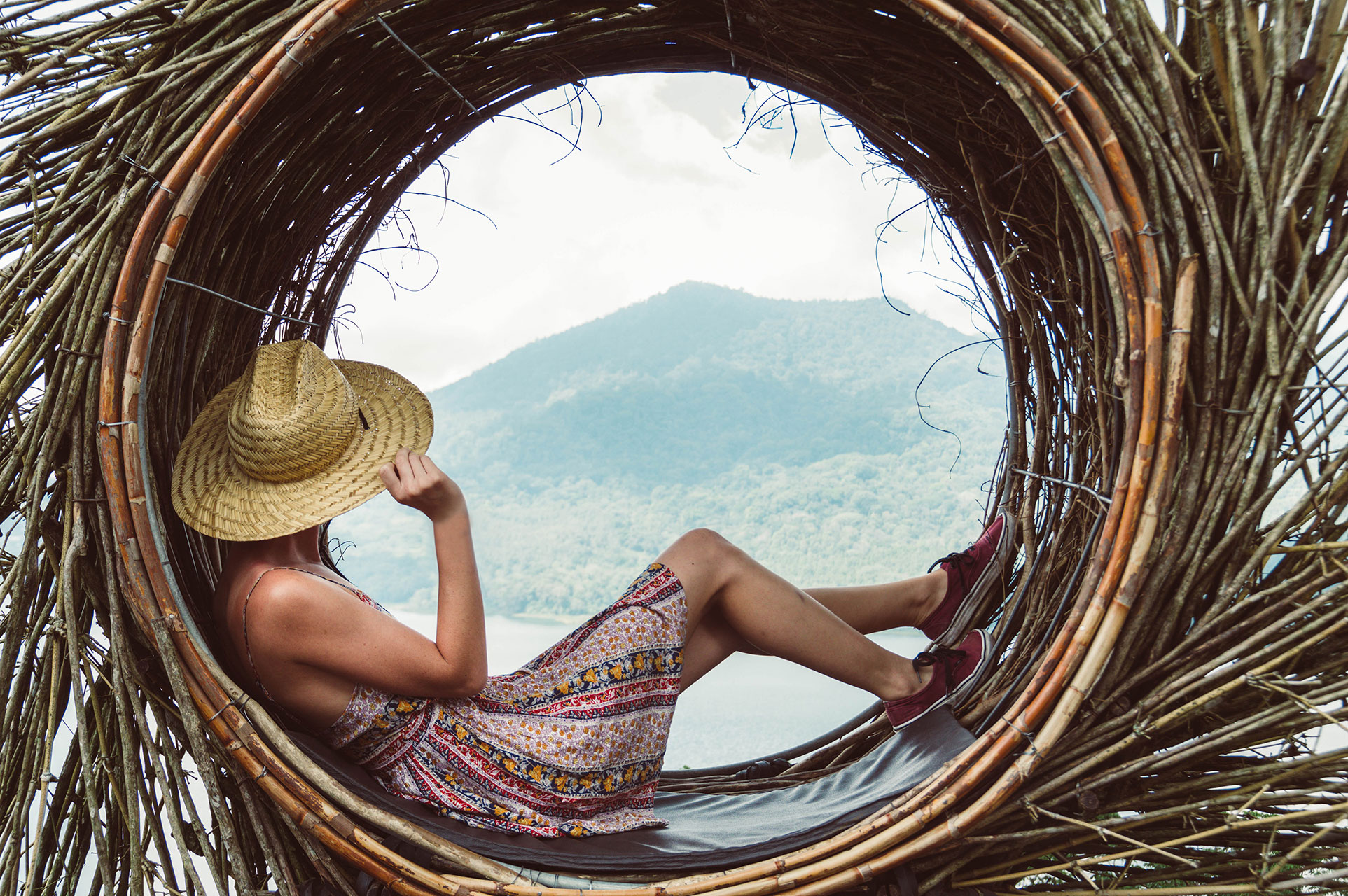 Traveller young woman sitting looking the mountain landscape at world trip